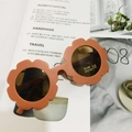 Detail of flower-shaped kids sunglasses with UV400 protection and CE safety labels - Matte Vibrant Orange