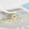 Macro shot of gold-plated evil eye pendant with pink zircon and sunray eyelash details - Pink Zirconia
