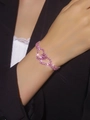 Elegant pink cubic zirconia double heart bracelet with full diamond pavé on model's wrist - Pink Double Heart