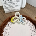 Gradient yellow blue acrylic bow hair claw clip placed on decorative lace paper - Butterfly Yellow Blue