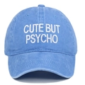 Close-up of 'CUTE BUT PSYCHO' white embroidery on washed blue cotton baseball cap - One Size / Light Blue