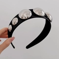 Black wide headband with large silver metallic studs held by hand against a grey wall - Round Hemisphere Headband