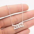 Close-up of gothic silver year 2002 pendant on a fine stainless steel chain - 2002 / Steel