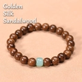 Golden silk sandalwood bracelet featuring a smooth pale green jade-like accent bead - Gold Silk Sandalwood 8mm With Green Jade