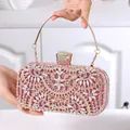 Detailed close-up of pink glitter evening bag with rhinestone floral patterns and gold handle - Pink