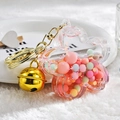 Quicksand flower acrylic keychain with colorful macarons and a gold bell - Pink with Bell