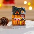 Macro detail of lighted resin ice cream house with snow accents and warm LED glow - Style G