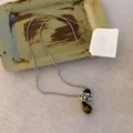 Detailansicht der Vintage-Halskette mit bernsteinfarbenem Tropfenanhänger und Silberkette - 8# Halskette - Silber - Tigerauge