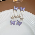 Detail of purple butterfly tassel earrings with crystals on a white carved plate - Long Tassel / Purple Butterfly