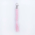 Handmade pink macrame keychain with silver metal clasp and fringe on white background - Light Pink