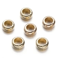 Macro detail of six polished gold-tone round spacer beads for DIY jewelry making - Gold Style 19 (Large Hole Round)