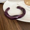 Macro detail of dark purple marble textured resin cuff with irregular wave design - Purple Marble