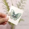 Elegant light green mesh butterfly hair clip with pearl detail on product card - Green Embroidered Butterfly