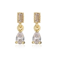 Macro shot of 18K gold plated teardrop zircon earrings with geometric rectangular studs - White