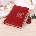 Short red bifold wallet for women with tassel, butterfly buckle and litchi texture - Red