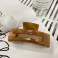 Large acetate hair claw clip featuring brown marble amber pattern for thick hair - Amber Marble