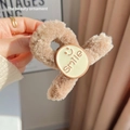 Warm camel plush hair claw clip featuring a soft faux fur texture and a smile emoji detail - Smile Plush Clip / Milk Coffee
