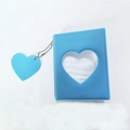 Detail of blue heart cutout 3-inch photo album with a matching heart charm and silver chain - Jelly Blue