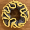 Crochet scrunchie with grey-blue and yellow layers on a rustic wooden background - Grey with Yellow Edge