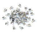Detailed macro view of bulk silver metal ribbon crimp ends with loop for DIY jewelry making - Rhodium