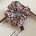 Detailed macro view of pink leopard print hair scrunchie with Made in Korea tag - Scrunchie / Pink Leopard