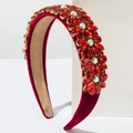 Detailed view of luxury baroque headband with red crystals and pearls on velvet - Red
