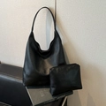 Black litchi-textured tote bag set with a matching pouch against a modern home background - Litchi Pattern Black