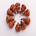 Brown sparkling gemstone gourd pendants with silver clasps in a circular layout - Gold Sandstone