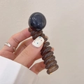Dark brown transparent spiral hair tie with a blue pearl bead, durable plastic material - Transparent Grey