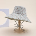 Blue reversible floral wide brim sun hat with adjustable drawstring on wooden stand - Little Floral / Green
