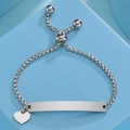 Macro shot of silver box chain bracelet with heart charm and blank curved metal bar - Silver Heart