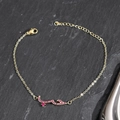 Detail of gold Arabic love charm bracelet with micro-paved ruby zircons on slate - Gold-Red Zircon