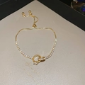 Detail of adjustable gold-plated bracelet featuring interlocking rings and cubic zirconia - Interlocking Rings Pendant Style / Gold - Circle