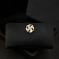 Golden spiral pin with sparkling crystals on a black cushion, premium jewelry design - 339# Windmill