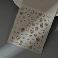 Detailed close-up of 3D gold nail stickers with vintage cross, sun and moon patterns - Baroque Vintage Star and Moon Border Gold (CO-526 Gold Stamping)