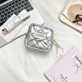 Detail of silver quilted pouch with Sezakka logo and ribbon on textured background - PU Rhombus-Silver