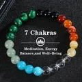 Macro view of 8mm 7 chakra natural stone energy beads bracelet on black leather background - 7 Chakras-2 (7 Chakras-2)