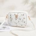 White embroidered camera bag with green vine floral pattern and gold butterfly buckle - White
