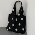 Detailed embroidery of white daisies with yellow centers on black canvas tote bag - Daisy Embroidery Black