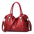 Close-up of red leather tote bag showing high-quality texture and golden hardware details - Burgundy
