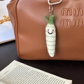 Handmade white wool felt radish keychain with smile embroidery on a leather bag - Happy Small Radish
