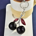 Fashionable black cherry keychain with red leaf detail and silver metal ring accessory - Black Cherry