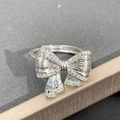 Macro shot of silver bow ring encrusted with small diamonds on a jewelry box edge - Bowknot Full Zirconia Luxury Style(JZ0404)