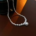 Macro detail of faux silver fragment and pearl necklace on a premium leather background - Necklace - Silver Pearl