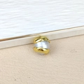 Macro view of a baroque freshwater pearl with irregular gold-plated metal texture wrap - Freeform Gold Border Baroque Pearl