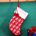 Red knit Christmas stocking featuring white tree pattern and decorative pom poms - Red Background Tree Sock