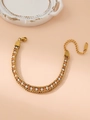 Golden woven bracelet with white pearls and amber gemstones on a peach background - Orange Zircon Pearl Gold