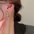 Minimalist silver geometric twisted hoop earrings for women shown on model ear - Minimalist Twisted Thick Hoop (24#)