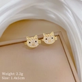Macro shot of gold cat-shaped earrings with white zircons and black rhinestone eyes - Cat Head Stud Earrings (P430)