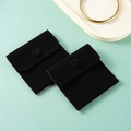 Two black velvet jewelry pouches with snap button closure on a soft green background - Double-sided Fleece Snap Button Style - Black; 7*7cm Fleece Bag